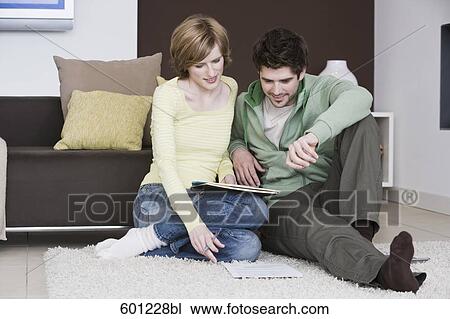 young couple reading documents at home together View Large Photo Image Stock Image - young couple reading documents at home together. Fotosearch