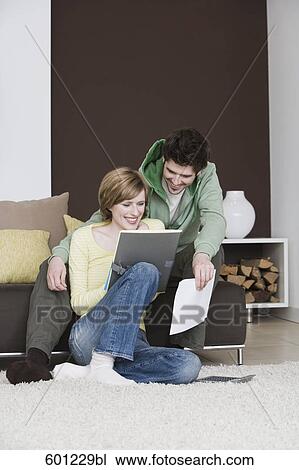 young couple reading documents at home together View Large Photo Image Stock Image - young couple reading documents at home together. Fotosearch