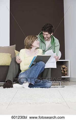 young couple reading documents at home together View Large Photo Image Stock Image - young couple reading documents at home together. Fotosearch