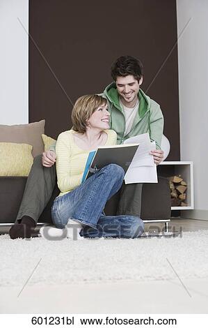 young couple reading documents at home together View Large Photo Image Stock Image - young couple reading documents at home together. Fotosearch