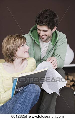 young couple reading documents at home together View Large Photo Image Stock Image - young couple reading documents at home together. Fotosearch