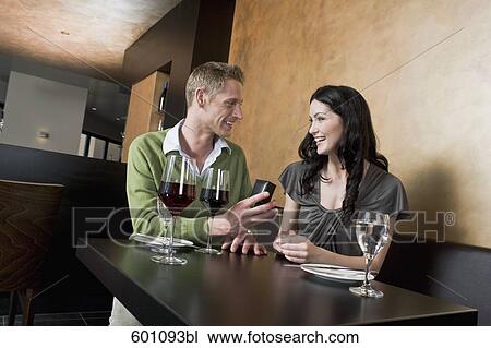 young couple sitting at restaurant man giving woman ring View Large Photo Image Stock Image - young couple sitting at restaurant man giving woman ring. Fotosearch