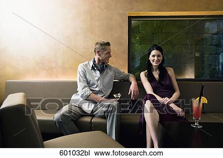 young couple sitting in bar flirting with each other View Large Photo Image Stock Image - young couple sitting in bar flirting with each other. Fotosearch