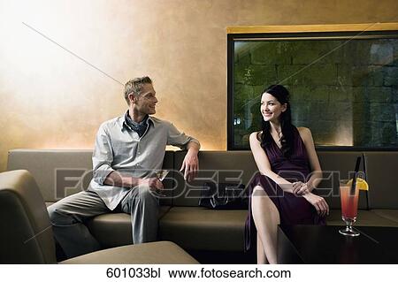 young couple sitting in bar flirting with each other View Large Photo Image Stock Image - young couple sitting in bar flirting with each other. Fotosearch