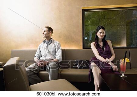 young couple sitting in bar looking away from each other View Large Photo Image Stock Image - young couple sitting in bar looking away from each other. Fotosearch