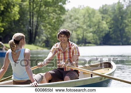 young couple sitting in rowing boat View Large Photo Image Stock Image - young couple sitting in rowing boat. Fotosearch