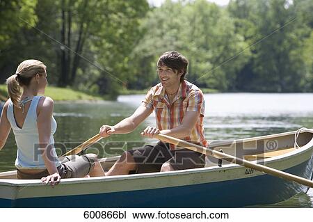 young couple sitting in rowing boat View Large Photo Image Stock Image - young couple sitting in rowing boat. Fotosearch