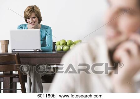 young woman at home working with laptop computer View Large Photo Image Stock Image - young woman at home working with laptop computer. Fotosearch