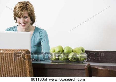 young woman at home working with laptop computer View Large Photo Image Stock Image - young woman at home working with laptop computer. Fotosearch