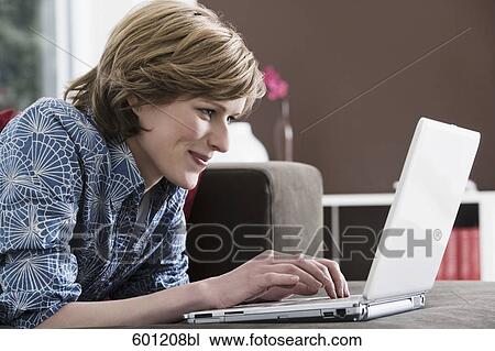 young woman at home working with laptop computer View Large Photo Image Stock Image - young woman at home working with laptop computer. Fotosearch
