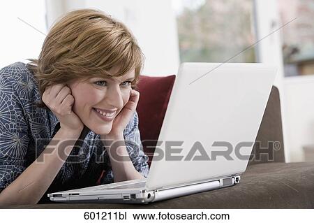young woman at home working with laptop computer View Large Photo Image Stock Image - young woman at home working with laptop computer. Fotosearch