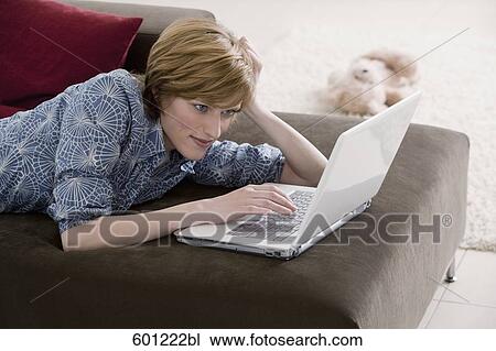 young woman at home working with laptop computer View Large Photo Image Stock Image - young woman at home working with laptop computer. Fotosearch