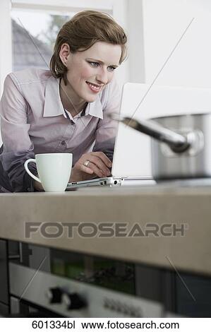 young woman at morning drinking coffee and looking at computer screen View Large Photo Image Stock Image - young woman at morning drinking coffee and looking at computer screen. Fotosearch