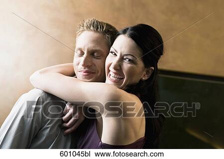 young woman embracing man in bar View Large Photo Image Stock Image - young woman embracing man in bar. Fotosearch