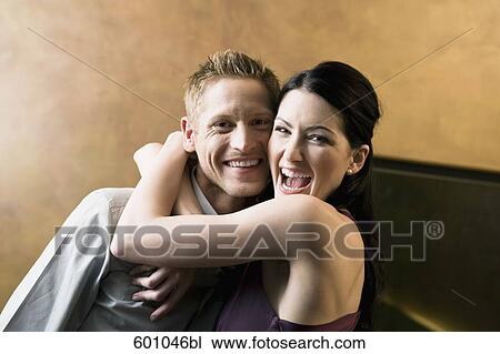young woman embracing man in bar View Large Photo Image Stock Image - young woman embracing man in bar. Fotosearch