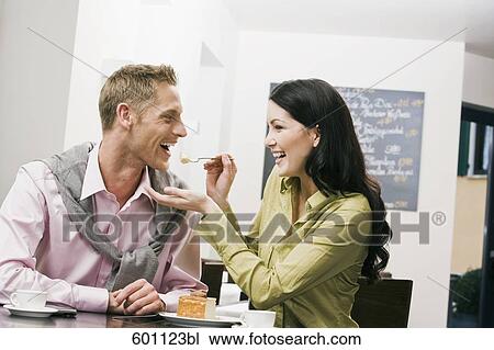 young woman feeding her boyfriend at cafe View Large Photo Image Stock Image - young woman feeding her boyfriend at cafe. Fotosearch
