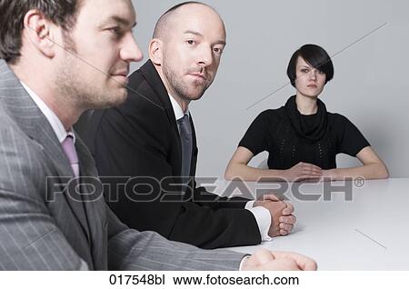 young woman sitting at conference table with two businessmen View Large Photo Image Stock Image - young woman sitting at conference table with two businessmen. Fotosearch
