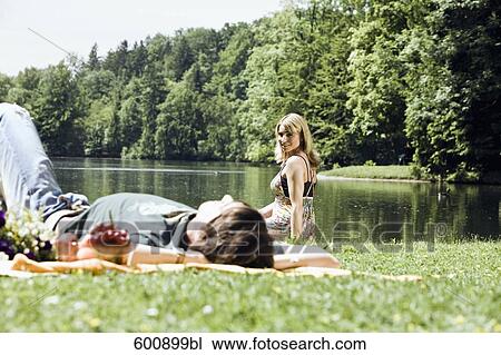 young woman watching her boyfriend sleeping in grass View Large Photo Image Stock Image - young woman watching her boyfriend sleeping in grass. Fotosearch