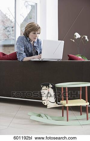 young woman working with laptop computer at home rocking horse in foreground View Large Photo Image Stock Image - young woman working with laptop computer at home rocking horse in foreground. Fotosearch