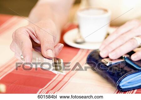 close-up of woman paying with credit card in cafe View Large Photo Image Stock Image - close-up of woman paying with credit card in cafe. Fotosearch
