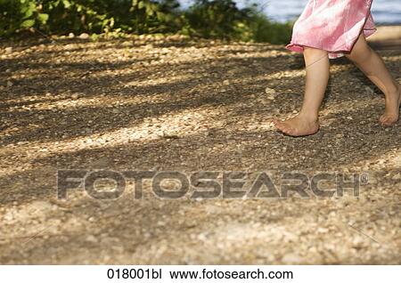 detail of little girl walking barefoot through forest View Large Photo Image Stock Image - detail of little girl walking barefoot through forest. Fotosearch