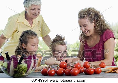 family preparing salad of tomatoes in garden View Large Photo Image Stock Image - family preparing salad of tomatoes in garden. Fotosearch