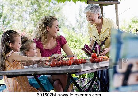 family preparing salad of tomatoes in garden View Large Photo Image Stock Image - family preparing salad of tomatoes in garden. Fotosearch