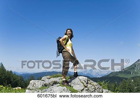full body portrait of mature woman standing on rock in the mountains View Large Photo Image Stock Image - full body portrait of mature woman standing on rock in the mountains. Fotosearch