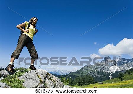 full body portrait of mature woman standing on rock in the mountains View Large Photo Image Stock Image - full body portrait of mature woman standing on rock in the mountains. Fotosearch