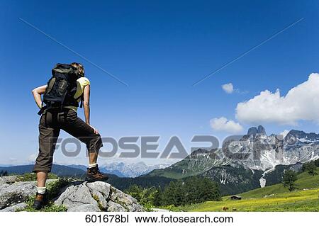 full body portrait of mature woman standing on rock in the mountains View Large Photo Image Stock Image - full body portrait of mature woman standing on rock in the mountains. Fotosearch