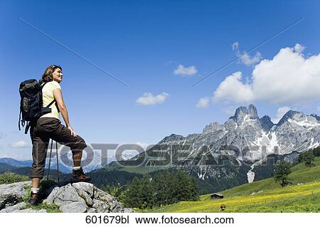 full body portrait of mature woman standing on rock in the mountains View Large Photo Image Stock Image - full body portrait of mature woman standing on rock in the mountains. Fotosearch