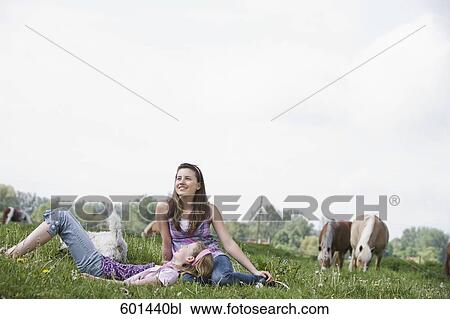 full body portrait of two girls sitting on meadow at horse ranch View Large Photo Image Stock Image - full body portrait of two girls sitting on meadow at horse ranch. Fotosearch