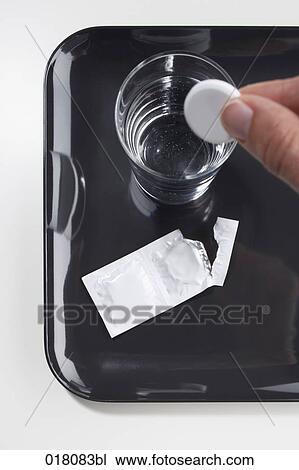 hand putting tablet into glass of water View Large Photo Image Stock Image - hand putting tablet into glass of water. Fotosearch