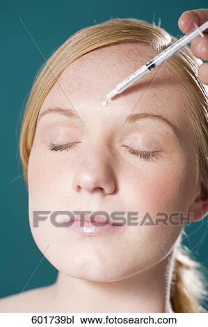 headshot of young woman getting injection in the face View Large Photo Image Stock Image - headshot of young woman getting injection in the face. Fotosearch