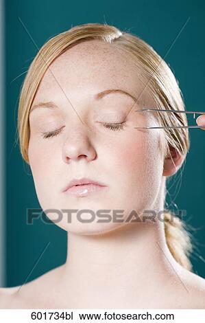 headshot of young woman with tweezers measuring face View Large Photo Image Stock Image - headshot of young woman with tweezers measuring face. Fotosearch