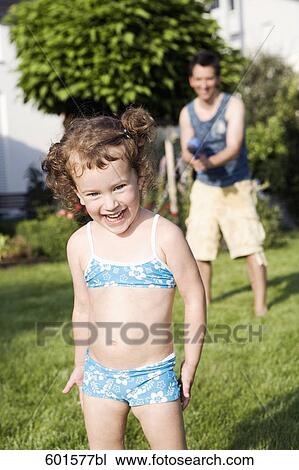 little girl standing in garden laughing View Large Photo Image Stock Image - little girl standing in garden laughing. Fotosearch