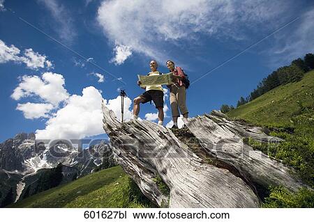 mature couple hiking in the mountains looking at map View Large Photo Image Stock Image - mature couple hiking in the mountains looking at map. Fotosearch