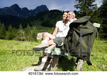 mature couple sitting on bench in the mountains View Large Photo Image Stock Image - mature couple sitting on bench in the mountains. Fotosearch