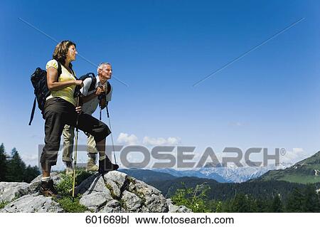 mature couple standing on rock in the mountains View Large Photo Image Stock Image - mature couple standing on rock in the mountains. Fotosearch