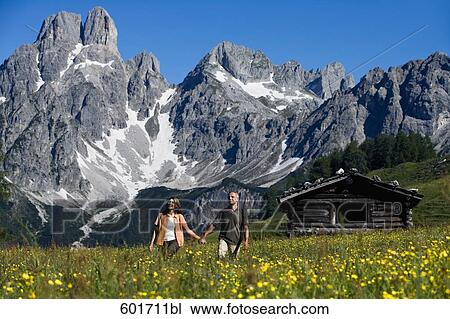 mature couple walking hand in hand in the mountains View Large Photo Image Stock Image - mature couple walking hand in hand in the mountains. Fotosearch