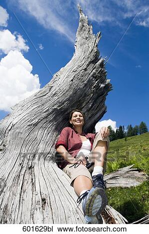 mature woman in the mountains relaxing on log View Large Photo Image Stock Image - mature woman in the mountains relaxing on log. Fotosearch