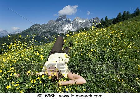 mature woman relaxing in grass in front of mountains View Large Photo Image Stock Image - mature woman relaxing in grass in front of mountains. Fotosearch