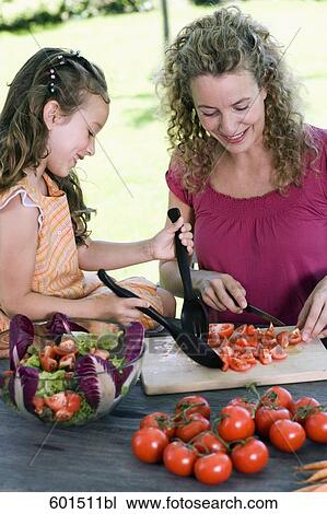 mother and daughter preparing salad of tomatoes in garden View Large Photo Image Stock Image - mother and daughter preparing salad of tomatoes in garden. Fotosearch