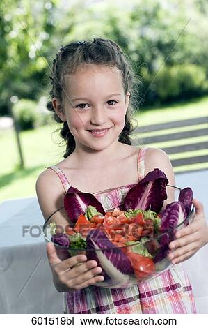 portrait of little girl holding bowl full of salad View Large Photo Image Stock Image - portrait of little girl holding bowl full of salad. Fotosearch