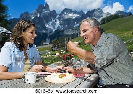 portrait of mature couple having meal in the mountains View Large Photo Image Stock Image - portrait of mature couple having meal in the mountains. Fotosearch