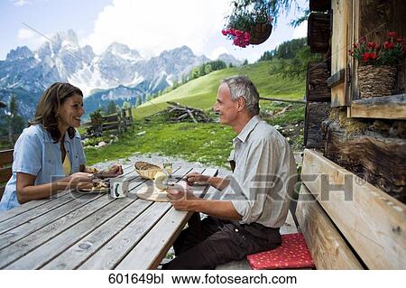 portrait of mature couple having meal in the mountains View Large Photo Image Stock Image - portrait of mature couple having meal in the mountains. Fotosearch
