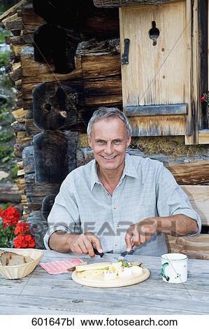 portrait of mature man enjoying meal in front of alpine hut View Large Photo Image Stock Image - portrait of mature man enjoying meal in front of alpine hut. Fotosearch