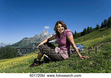 portrait of mature woman relaxing on meadow in the mountains View Large Photo Image Stock Image - portrait of mature woman relaxing on meadow in the mountains. Fotosearch