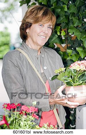 portrait of senior woman buying flowers View Large Photo Image Stock Image - portrait of senior woman buying flowers. Fotosearch
