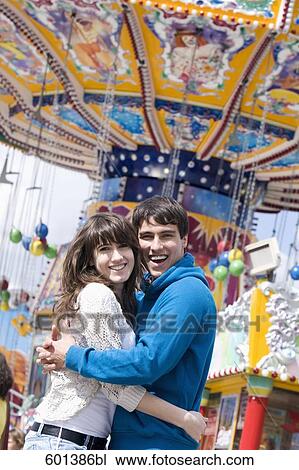 portrait of teenage couple embracing at fun fair View Large Photo Image Stock Image - portrait of teenage couple embracing at fun fair. Fotosearch